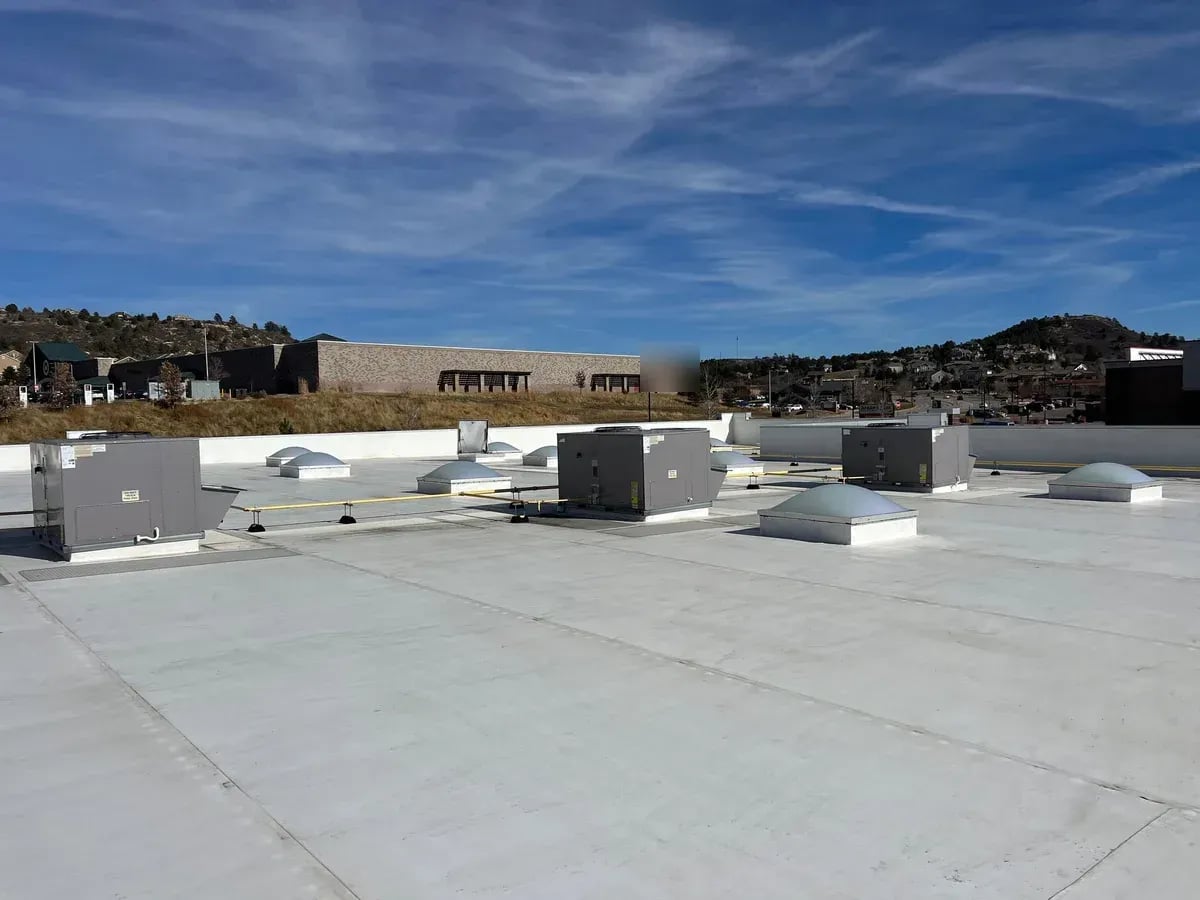 White TPO commercial roof with skylights and rooftop units