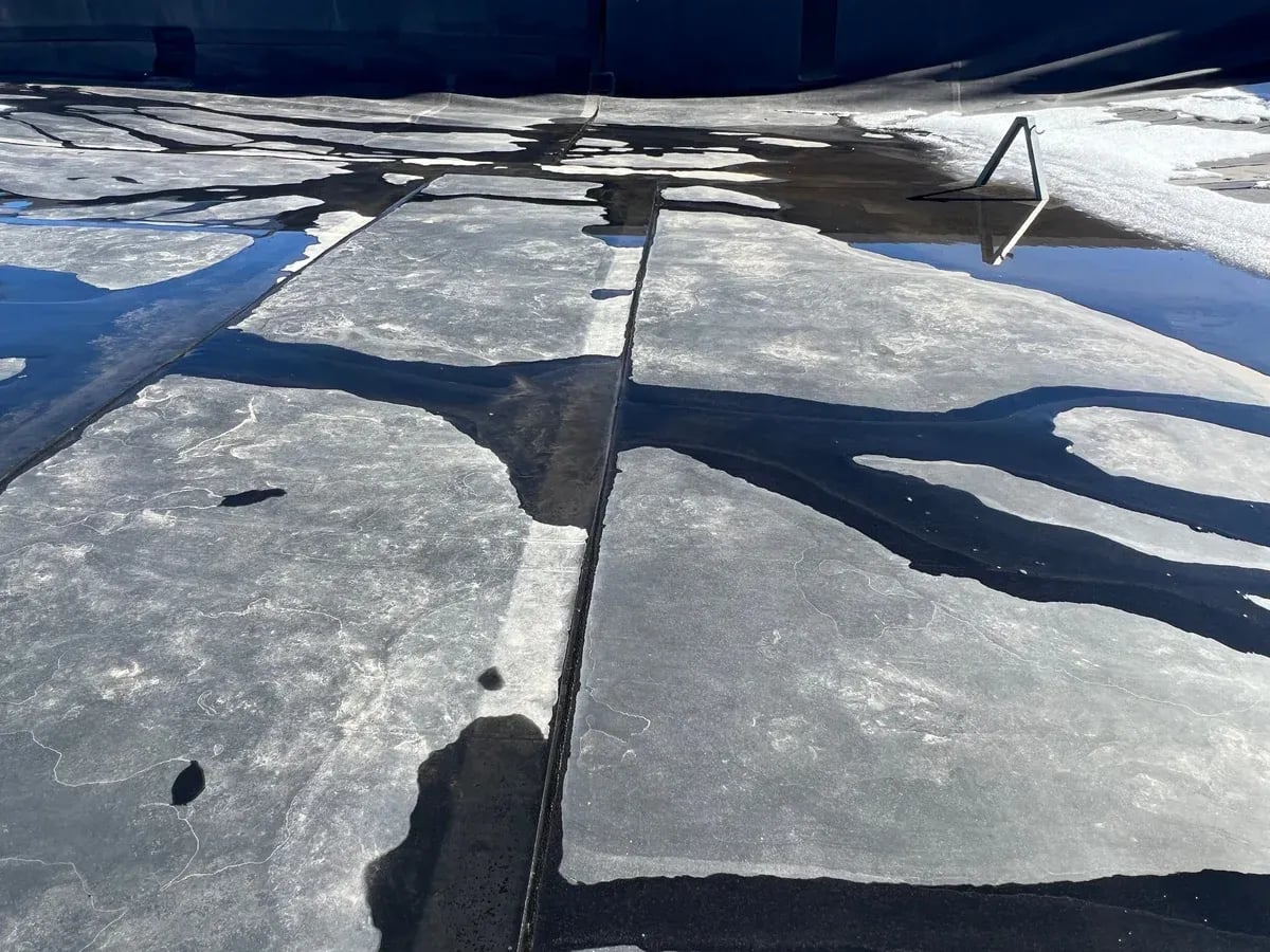 Ponding water across the seams of an aging modified bitumen flat roof