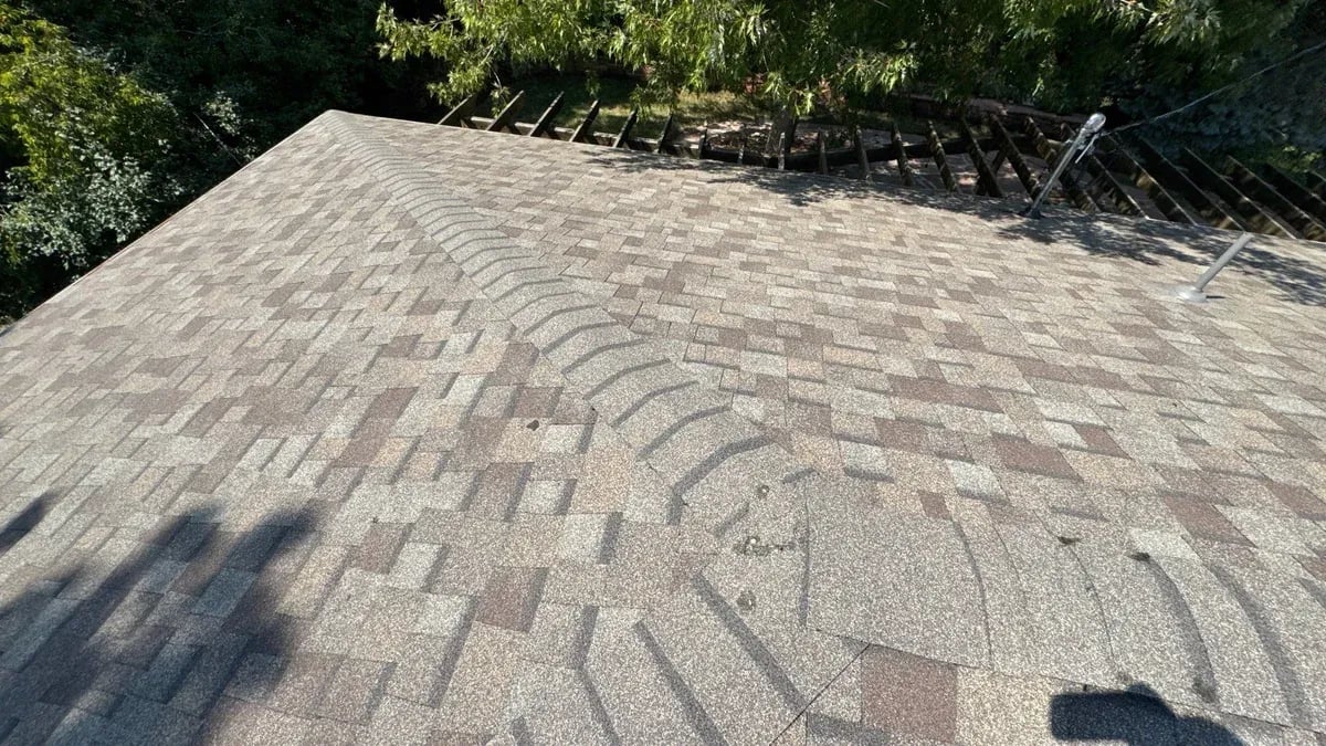 Close view of ridge cap shingles laid over a hip on the finished roof