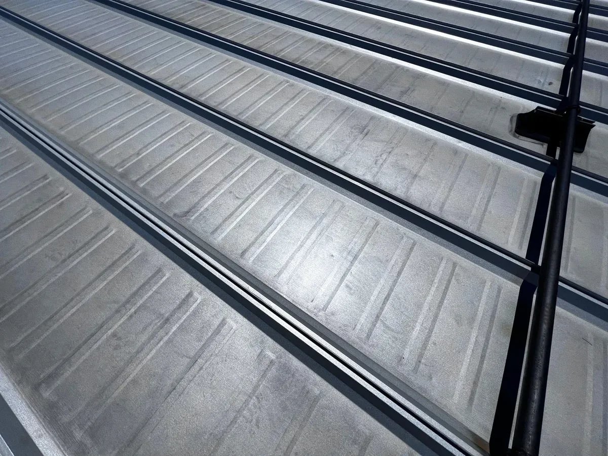 Close view of silver standing seam ribs on a metal roof