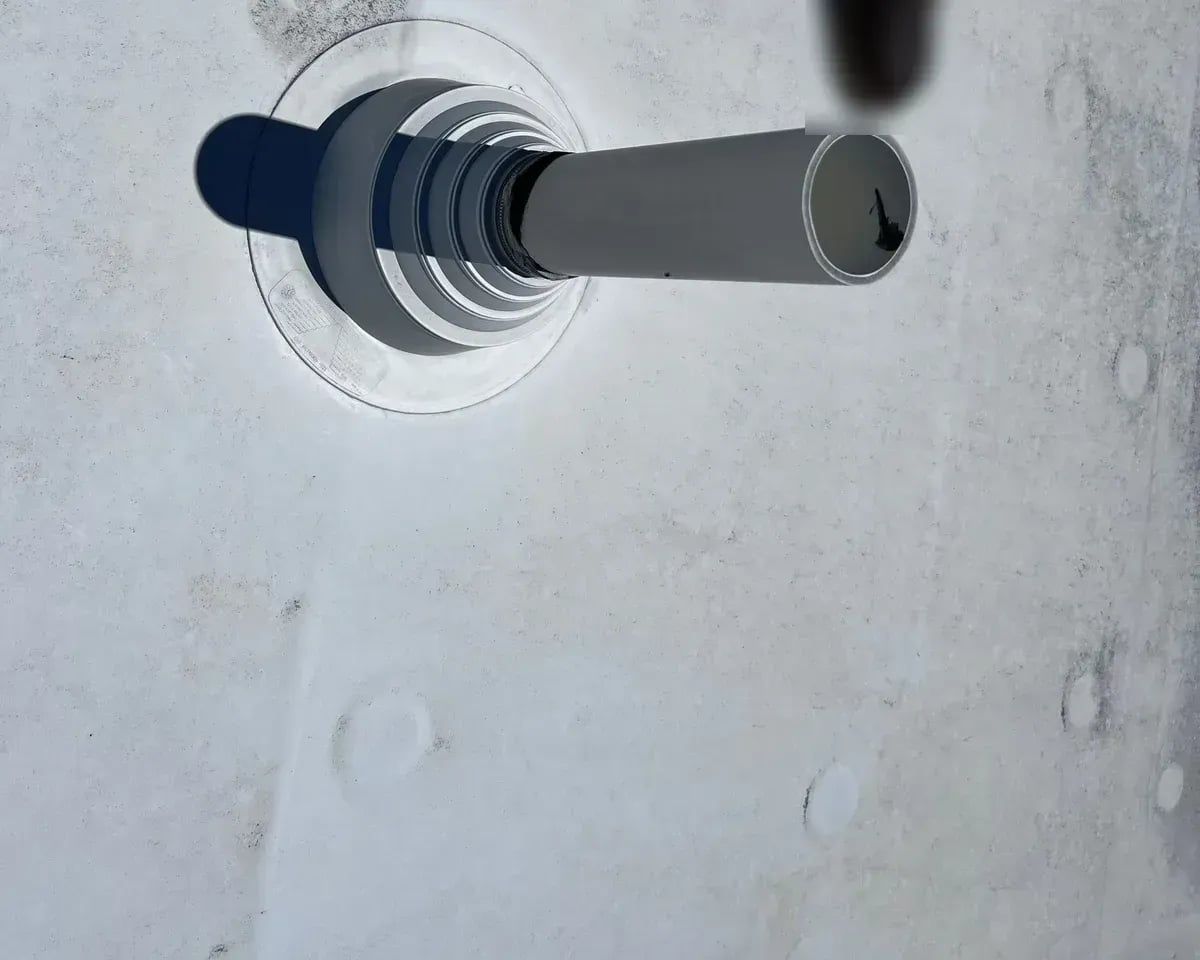 Pipe boot flashing sealed to a white TPO membrane